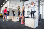 Crossfit group trains box jumps